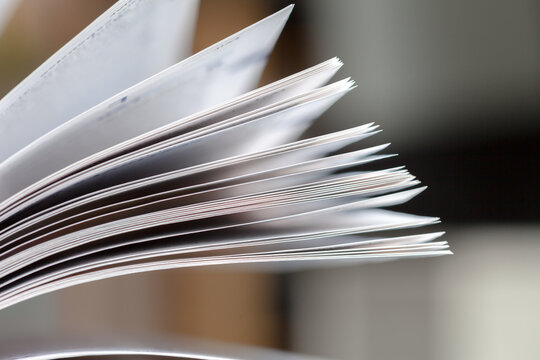 stack of books. Close up opened book page with blurry background.