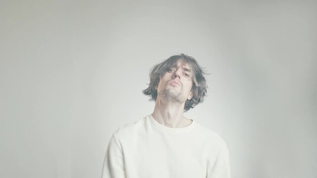 Comical shaggy-haired man looking upward with an exaggerated arrogant expression