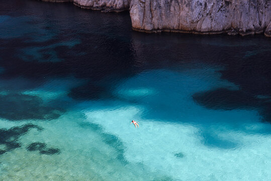 Woman Swimming in the Crystal Clear French Riviera Waters of Calanque d&rsquo;En-Vau During Summer in France