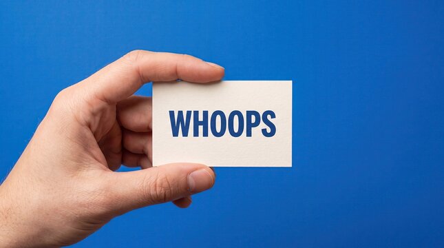 Hand holding whoops sign on blue background mistake concept