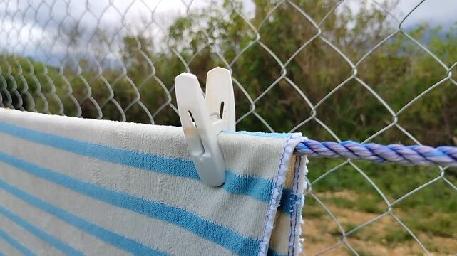 Clothespin Holding Towel on Clothesline Close Up