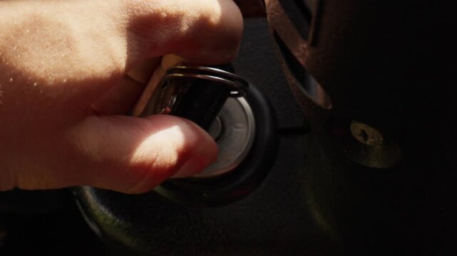 Hand Inserting Key into Vintage Car Ignition Lock Closeup &mdash; Classic Automobile Interior Video