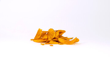 Fototapeta premium A small pile of ridged potato chips, seasoned with orange flavoring, arranged in a cluster and isolated on white background