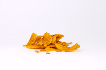 Fototapeta premium A small pile of ridged potato chips isolated on white background