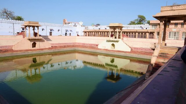 Historic Stepwell Water Reservoir with Traditional Pavilion Architecture and Reflection