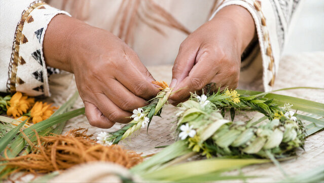 Woman hand weaving traditional lei flower crown. Indigenous person creating natural floral wreath for cultural celebration. Handcraft art of native islander heritage and folk craft.