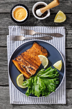 BBQ salmon fish on plate with fresh salad