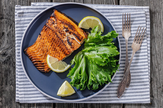 BBQ salmon fish on plate with fresh salad