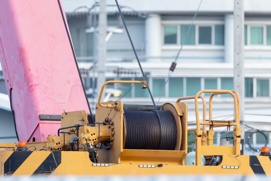 Pink crane arm looms above yellow equipment