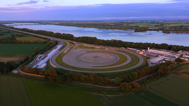 Drone video of an automotive testing site in Bavaria featuring structured proving grounds, engineering buildings and rural farmland