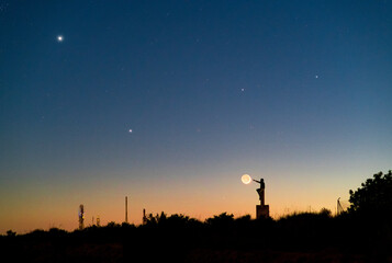 Night sky astrophotography of rare celestial conjunction with stars and astronomer silhouette © Hector