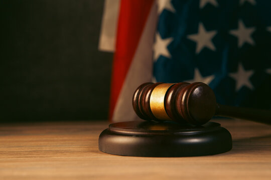judge gavel and american flag on wooden table. justice concept
