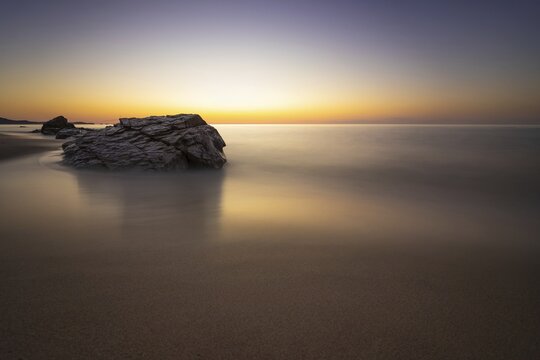 The sun rises on the Costa Rei, a stretch of coastline on the Italian Mediterranean island of Sardinia, Monte Nai, Costa Rei, Sardinia, Italy