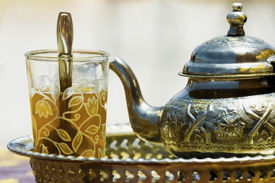 Silver teapot and tea glass with peppermint tea, Morocco