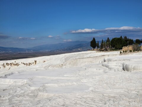 White Travertine Pools of Pamukkale Under Blue Sky