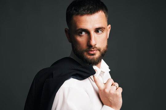Handsome confident man with jacket over shoulder
