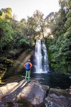 Hiker at McLean Waterfall, Sun Star, Catlins, Otago, South Island, New Zealand