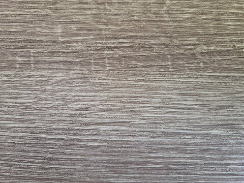 Gray wood grain texture background with natural linear patterns, ideal for flooring, furniture, or design backdrops 