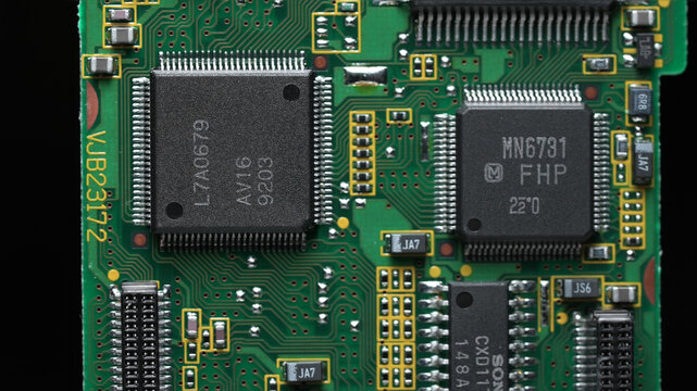classic green motherboard with chipsets, memory modules, transistors and contacts