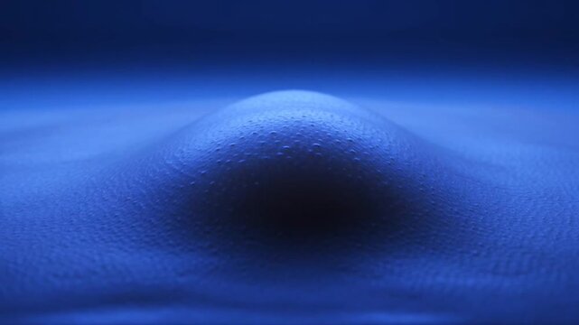 Abstract blue fluid wave rising in slow motion.