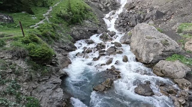 Aerial Drone View of Wild Alpine Mountain Stream Rushing Over Rocks in Swiss Alps Switzerland