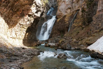 Long exposure shot of Estrecho Waterfall (Cascada del Estrecho) on sunny spring day. Ordesa y Monte Perdido National Park, Spain. © Kirill