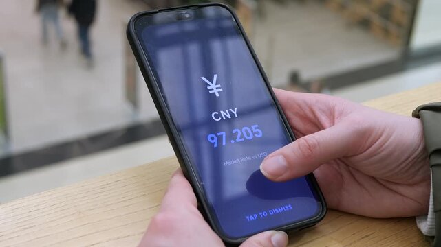 User navigating a clean list of currency pairs. Multiple global currencies displayed with their values. High demand for stock video in economic reporting, mobile banking, and fintech marketing.