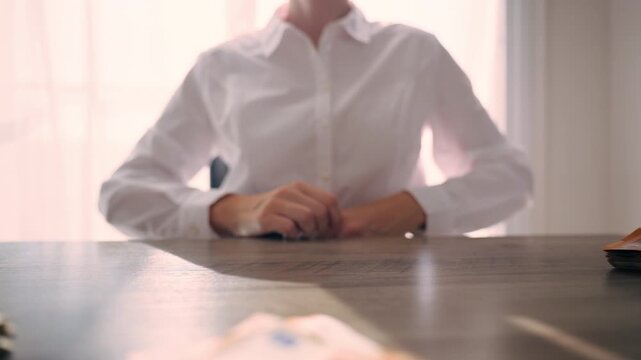 Frustrated businesswoman counting euro banknotes at office desk, showing dissatisfaction with salary and financial stress during personal budgeting and money management.salary frustration, stress
