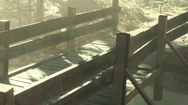 A wooden bridge spans a path in a forest scene. Sunlight shines softly through the trees, casting shadows on the bridges surface. The area appears green and natural.