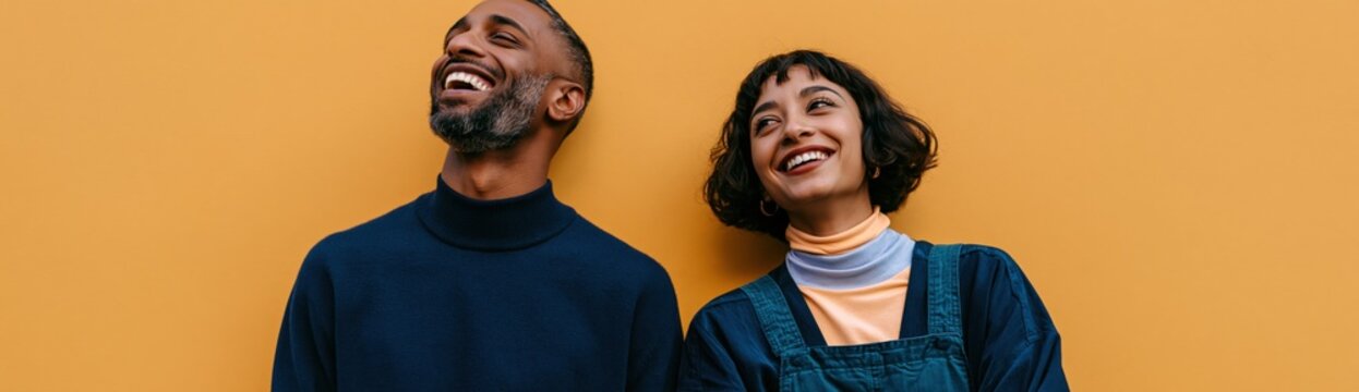 Smiling diverse young couple against orange wall background for banner and website header and lifestyle design