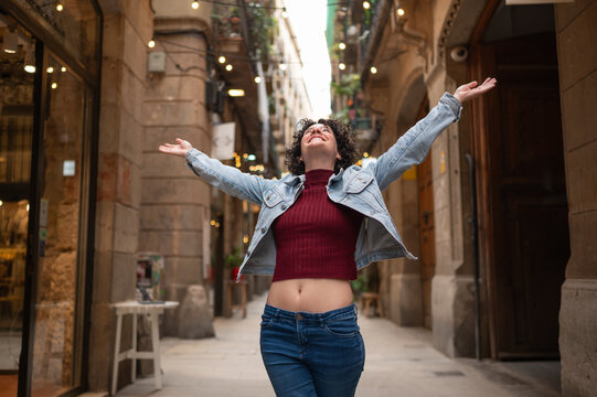Young woman enjoying freedom and happiness on city street