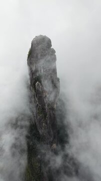 Aerial drone footage of Dedo de Deus granite spire rising above the Atlantic Forest in Teres&oacute;polis, Brazil.