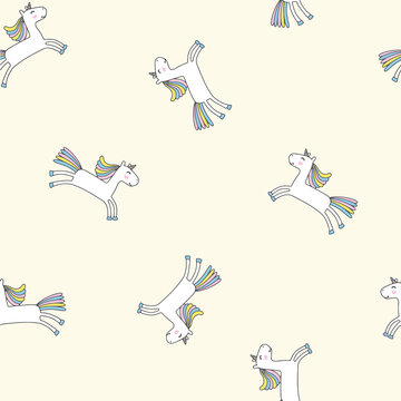 Whimsical Unicorns leaping with rainbow manes on a soft cream background seamless pattern