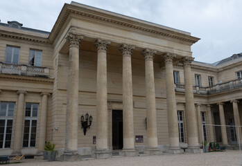 Fototapeta premium Classical/Neoclassical building façades, columns, pediments, Statues, Greco-Roman shapes and design, Ornaments... From this Architectural style inspired by Classical Antiquity. Mostly taken in Paris.