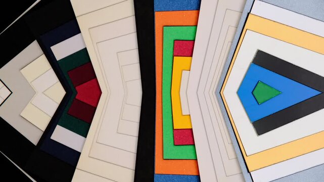 A vibrant collection of colored mat board samples arranged in nested geometric layers