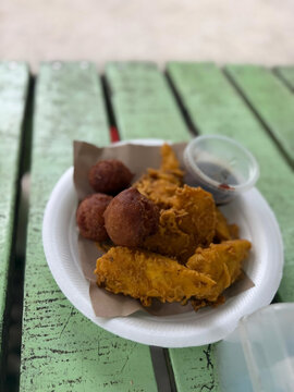 Malaysian Crispy Banana Fritters and Cekodok Pisang with Spicy Sweet Soy Sauce Sambal Kicap on Green Wooden Table