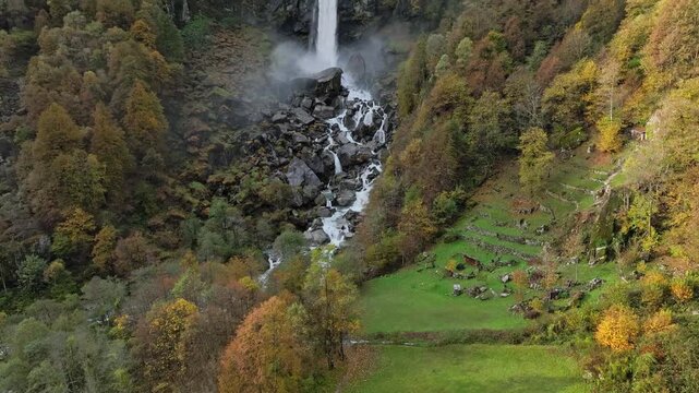 Aerial Drone View of Foroglio Waterfall Cascading Down Rocky Alpine Cliff in Autumn, Switzerland