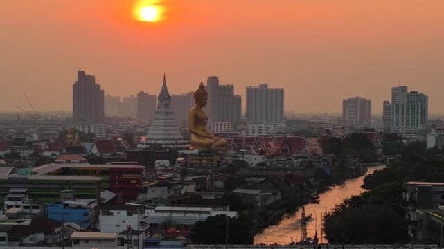 Wat paknam phasi charoen golden buddha statue sunset light aerial view travel in Bangkok Thailand