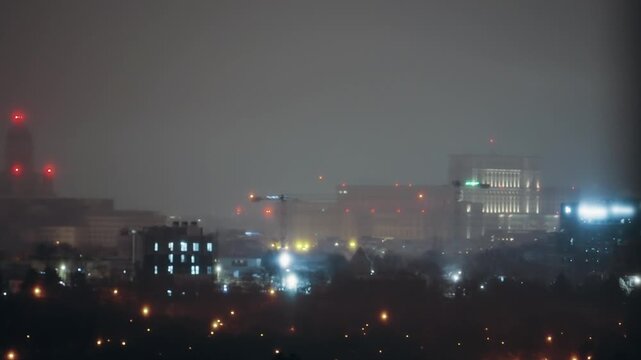 Aerial Night View: Parliament Bucharest Shrouded in Winter Fog