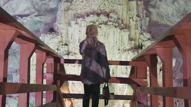 Tourist Woman Explores Slanic Unirea Salt Mine Stairs, Romania