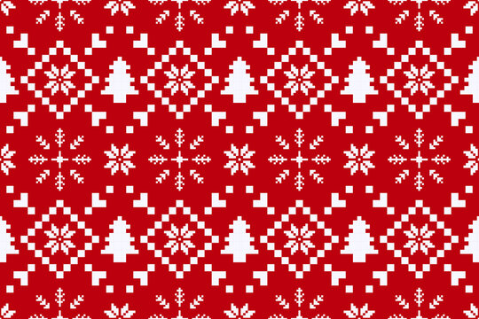 Christmas and New Year seamless pattern. White snowflakes on red pixel pattern for winter hat,jumper,sweater, wrapping,fabric,border,rim,carpets, blankets, towels