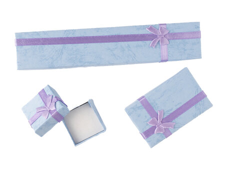 baby blue cardboard jewelry boxes with ribbon bows   flat lay