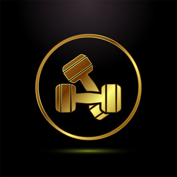 Two golden dumbbells crossed icon or symbol in a shiny metallic circle on a black background.