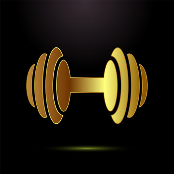 Golden dumbbell with a glossy finish on a dark background showing strength and fitness.