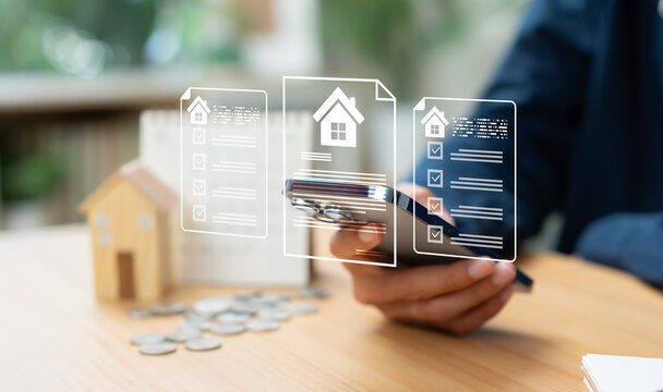 Businessman reviewing property documents and housing market information on smartphone, analyzing real estate prices, home financing options, investment value, and market trends
