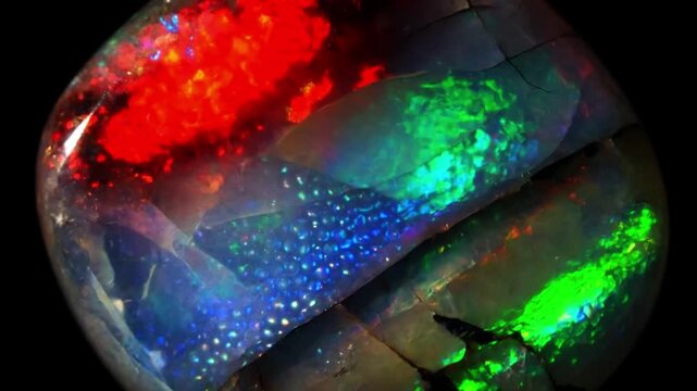 Opal gemstone internal structure with shifting play of color, precious stone abstract background seamless loop
