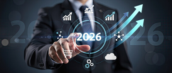 Businessman touching a futuristic interface displaying the year 2026 with upward trending graphs and business icons.