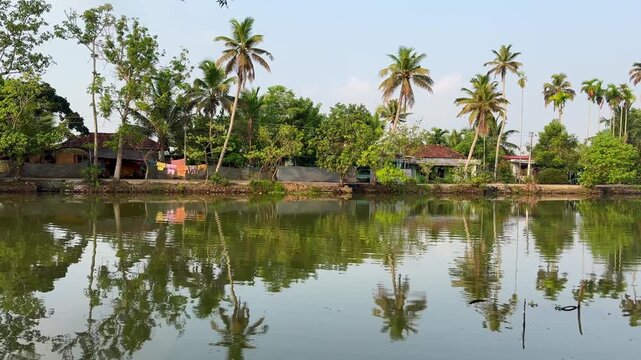 Scenic view of Kerala backwaters with calm waters, lush greenery, and traditional landscape, capturing the serene beauty and tranquil lifestyle of Kerala	
