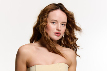Fototapeta premium Beautiful young woman exudes charm and allure in a stylish studio setting