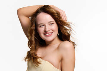 Fototapeta premium Young beautiful woman showcasing her captivating style in a vibrant studio setting
